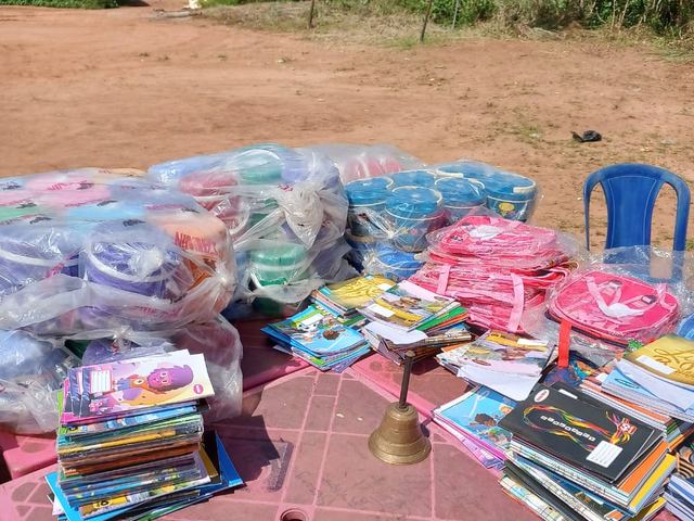 Tables laid out with bags, books and lunch kits before the handover.