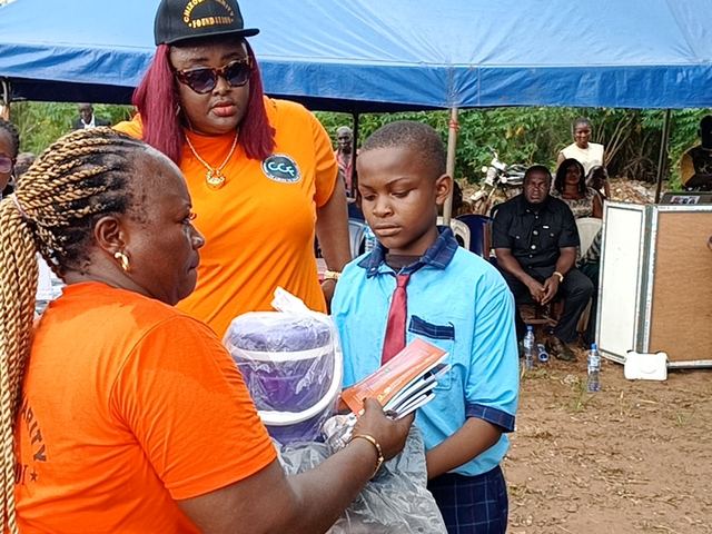 A pupil receives her pack from one of the Foundation's volunteers.