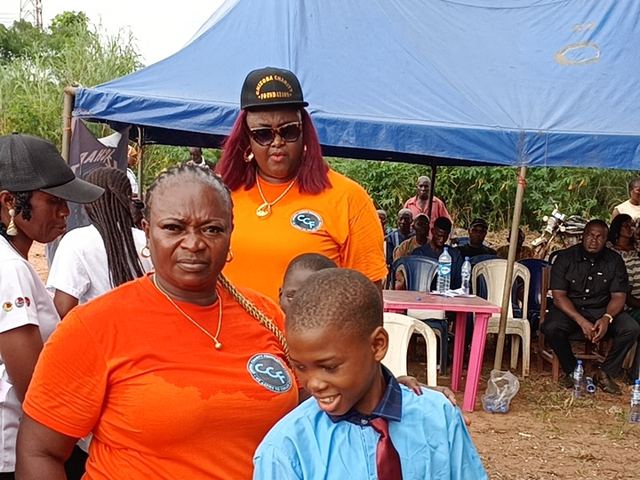 Handing over a lunch kit to go with the books and bag.