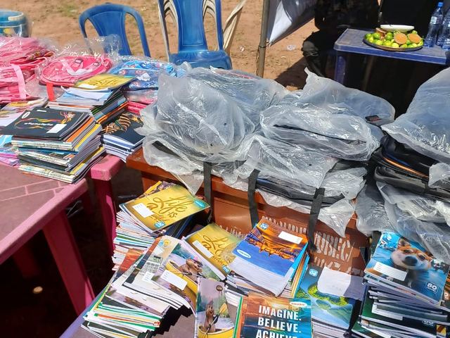 Textbooks and exercise books ready for the handover.