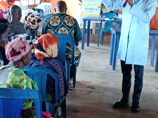 Residents listen as the doctor explains how the day's screening will run.