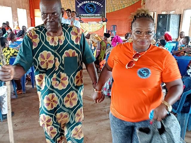 Helping an elder across the hall — nobody queues alone.