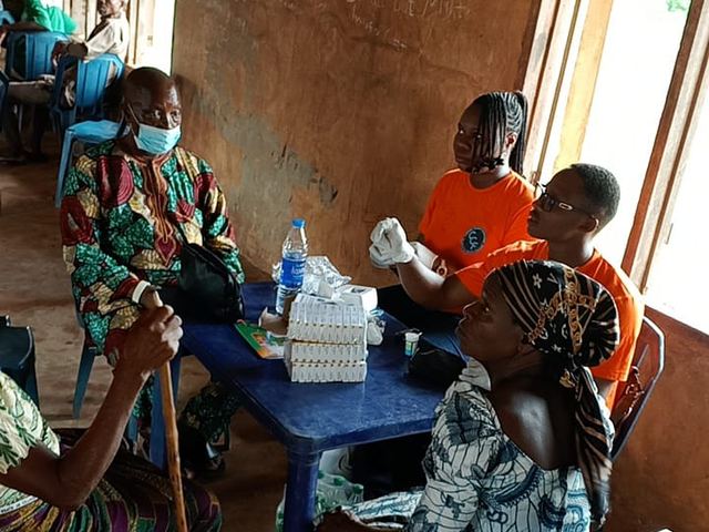 Foundation volunteers attending to beneficiaries one by one.