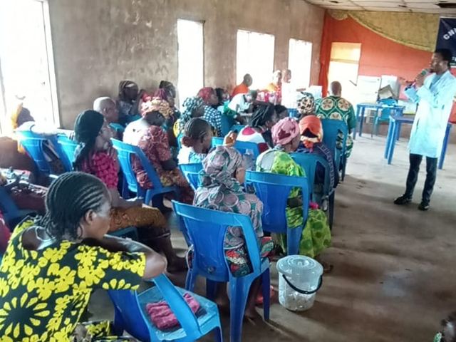 Community members seated and waiting their turn for screening.